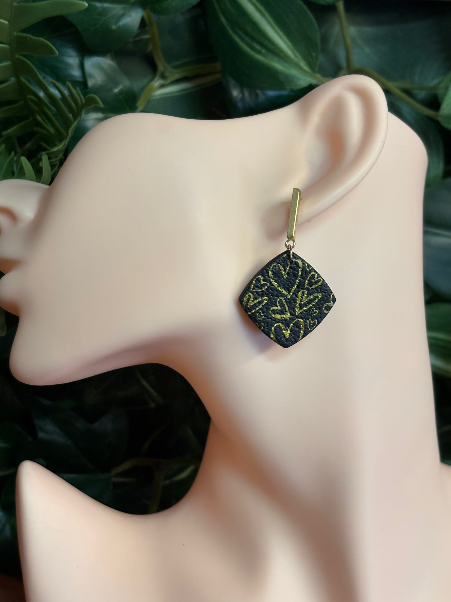 The one with the hearts rounded square black/gold