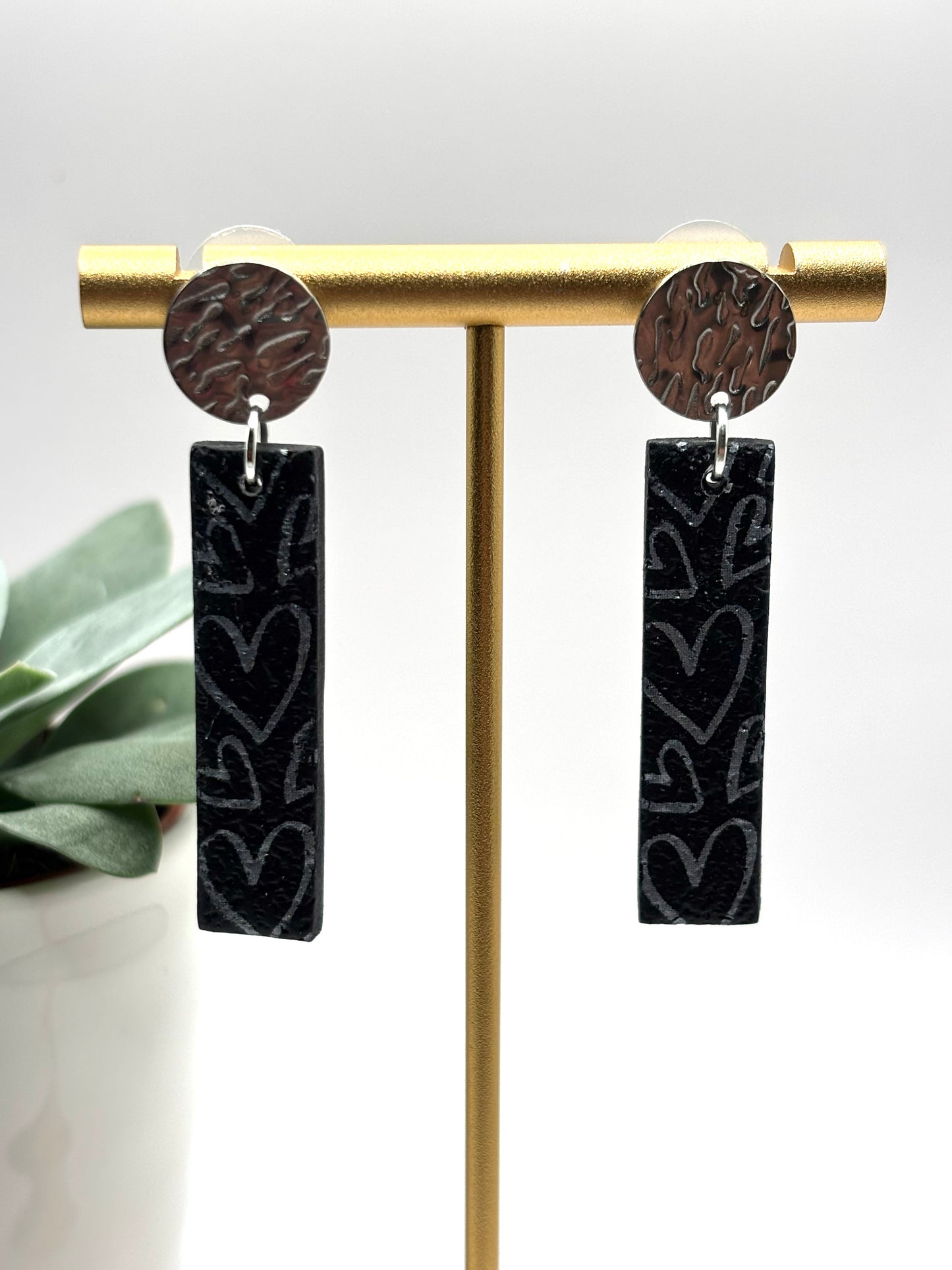The one with the hearts rectangle black/silver