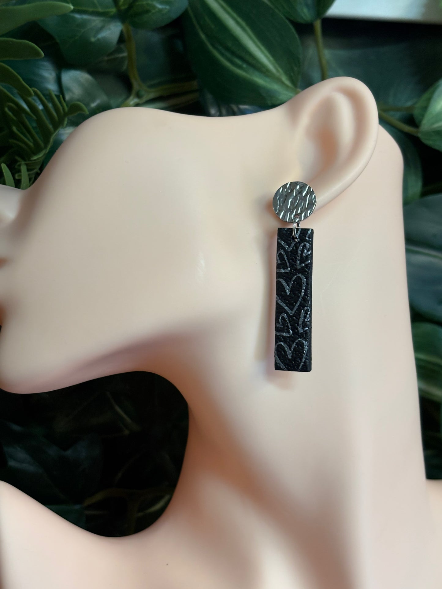 The one with the hearts rectangle black/silver