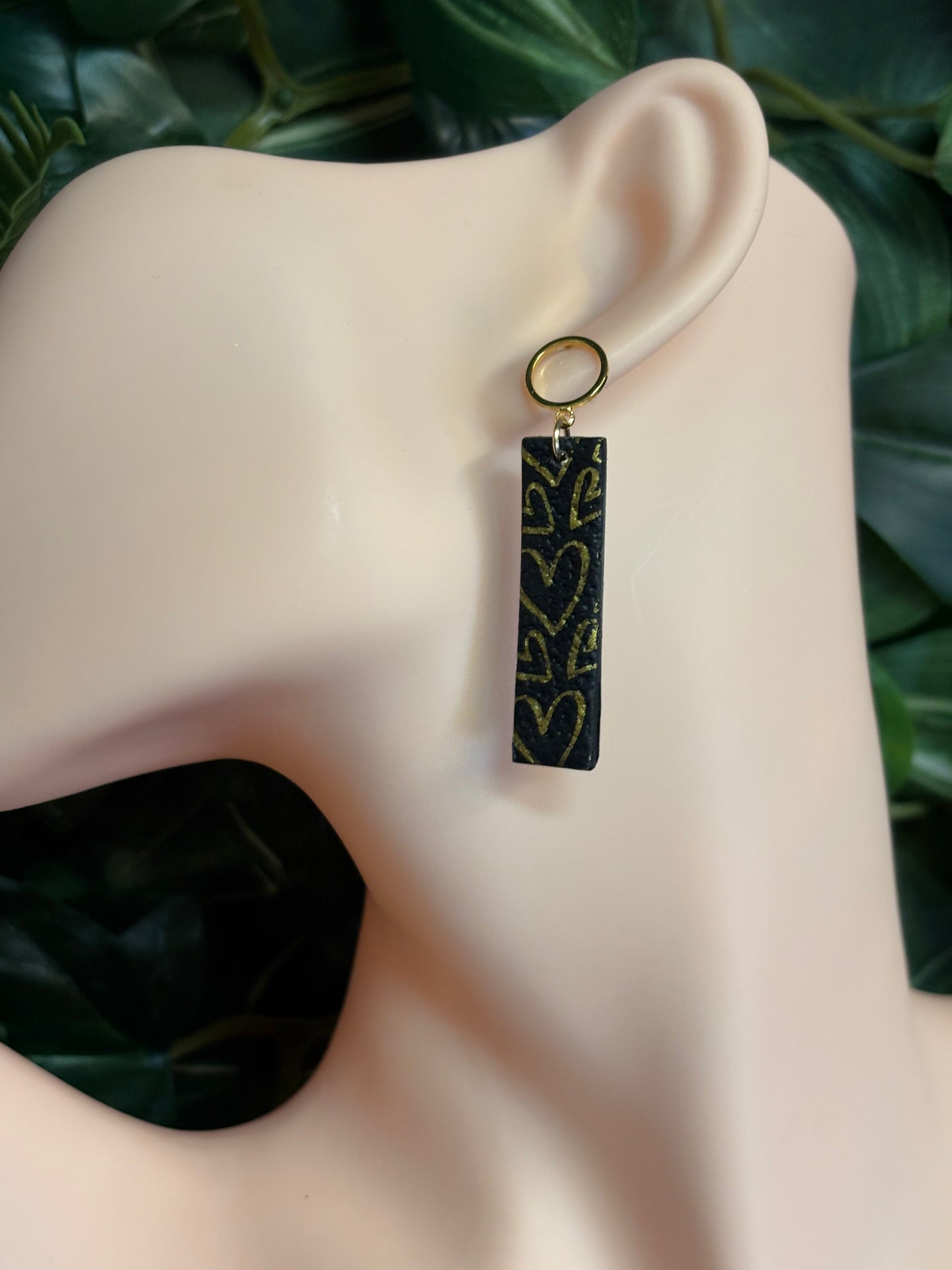 The one with the hearts rectangle black/gold